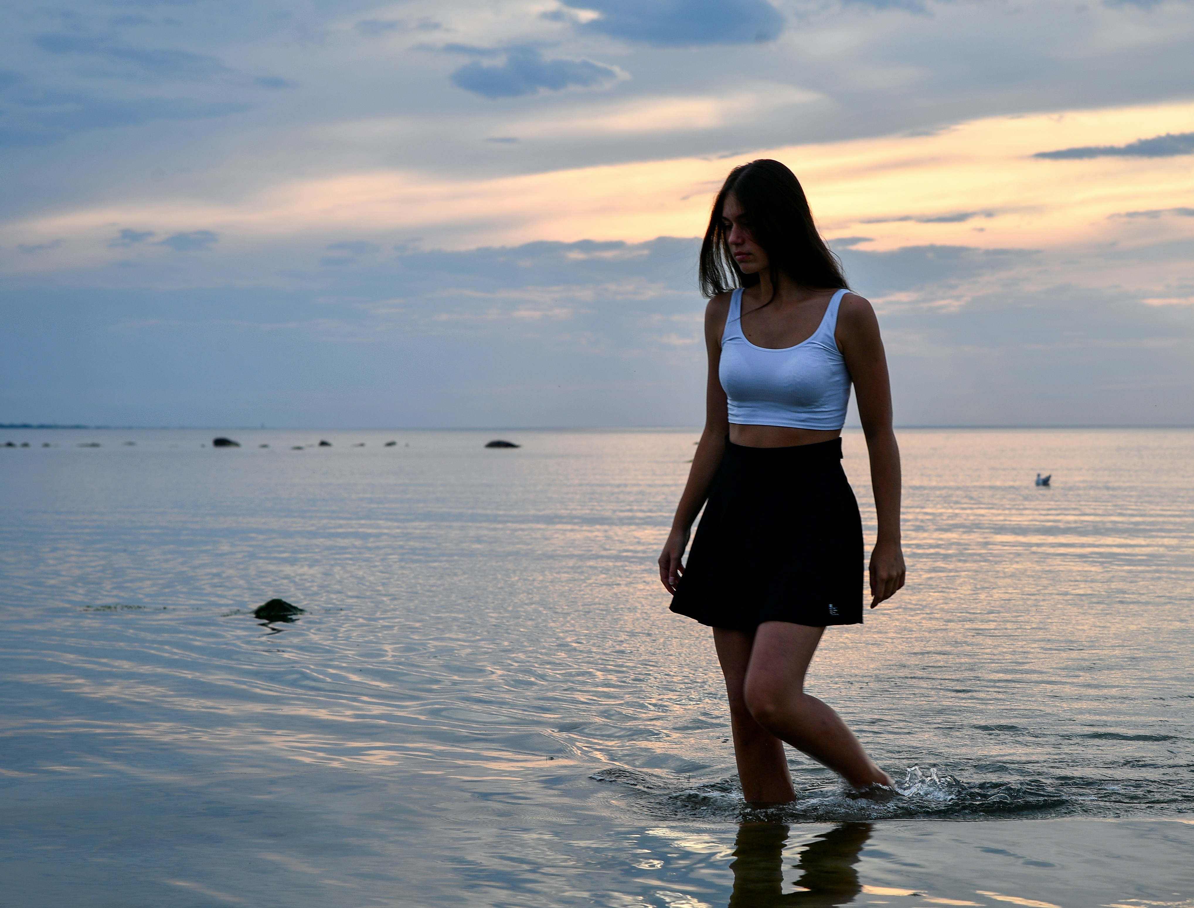 Woman walking on Shirahama white sand beach Japan at sunset