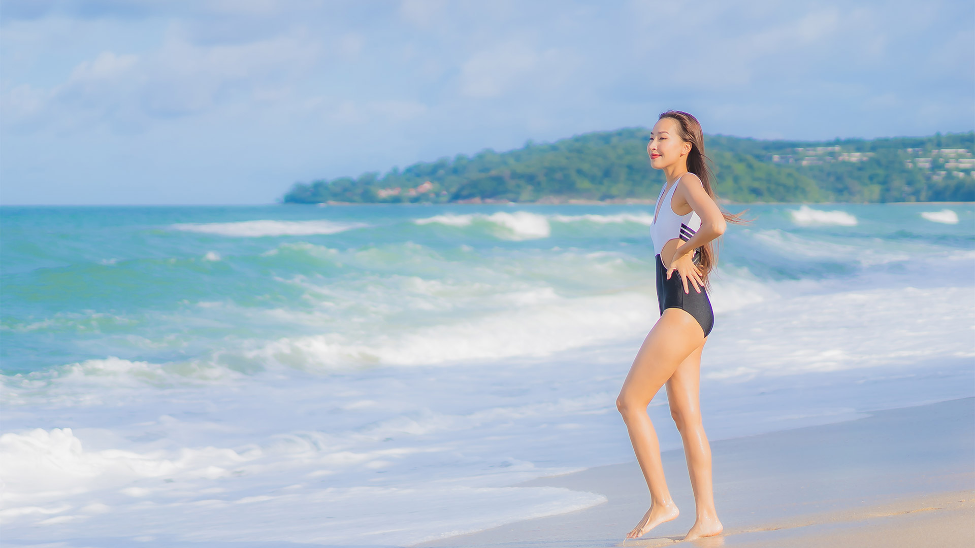 Woman at Miyako-jima Japan overlooking emerald tropical lagoon